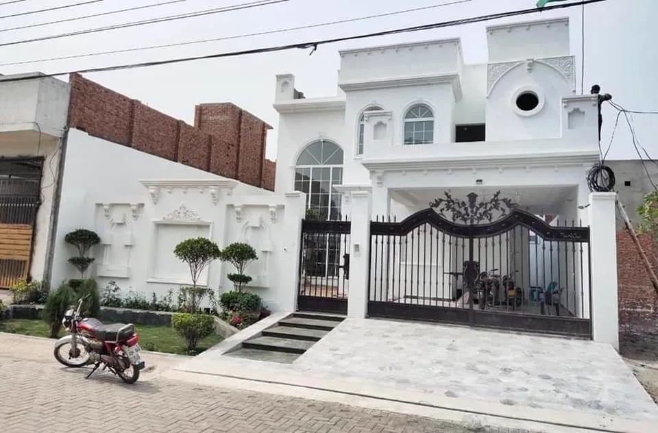 Arched aluminum-framed windows installed on a house exterior in Lahore