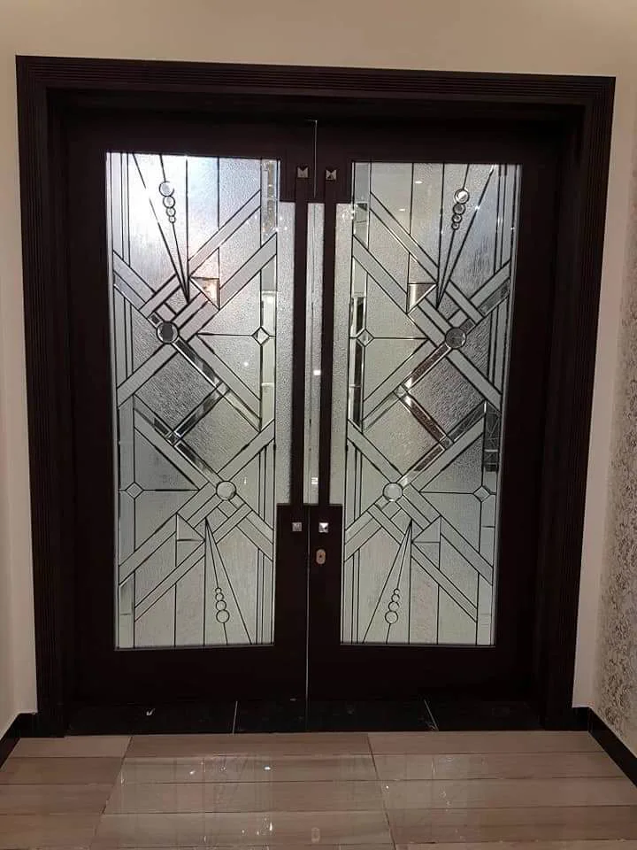 Double entrance door with decorative frosted geometric glass panels