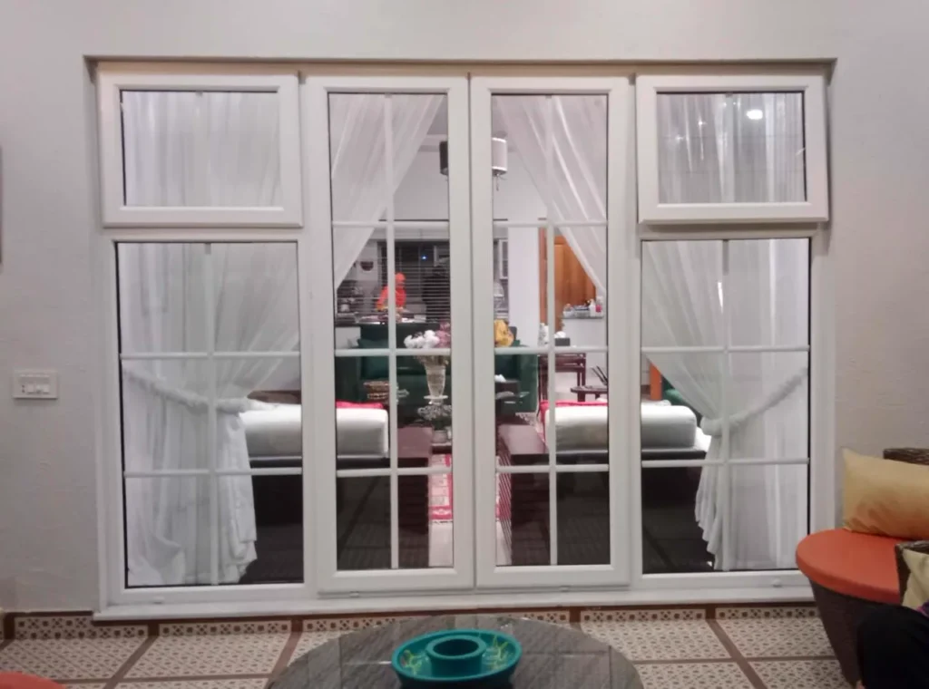 White-framed glass double door with grilles and sidelights