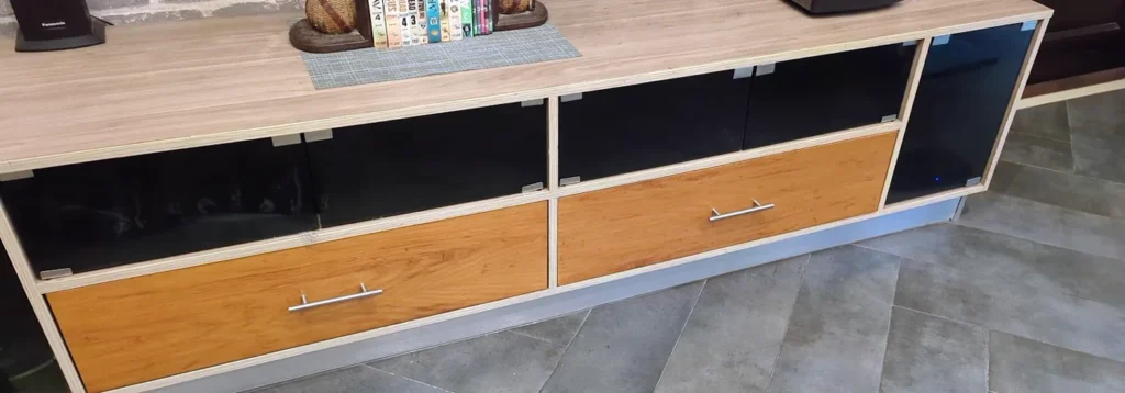 TV console fitted with black glass push-to-open mirror doors