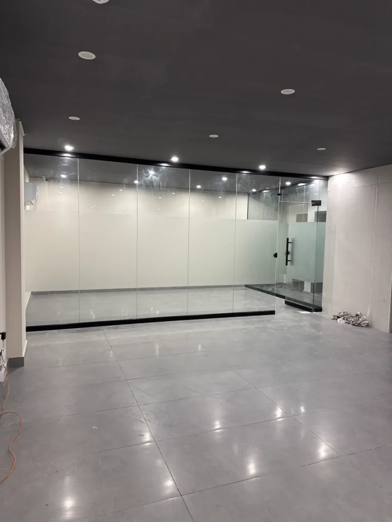 Frameless glass office partition walls with black framing channels